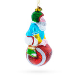 Santa Football Player with Sports Ball Blown Glass Christmas Ornament ,dimensions in inches: 5 x 4 x