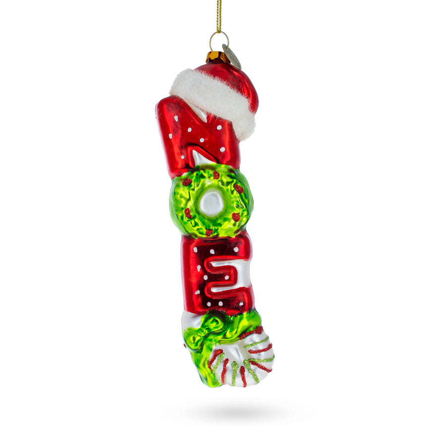 Glass "Noel" Sign Topped with Santa Hat Glass Christmas Ornament in Multi color