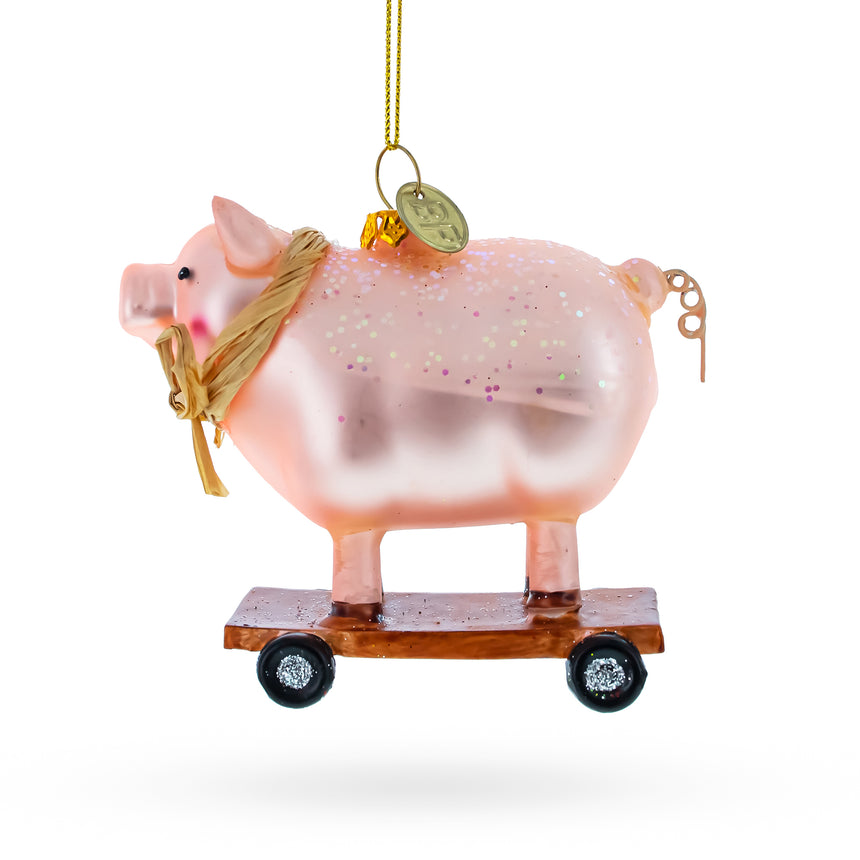 Glass Playful Pig Riding a Skateboard Glass Christmas Ornament in Pink color