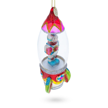 Trailblazing Astronaut Inside Spaceship Blown Glass Christmas Ornament ,dimensions in inches: 6.5 x 2.29 x 2.09