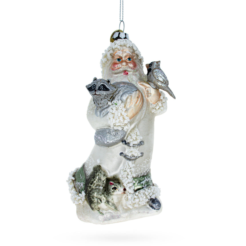 Glass Santa Holding Cardinal and Raccoon Glass Christmas Ornament in White color