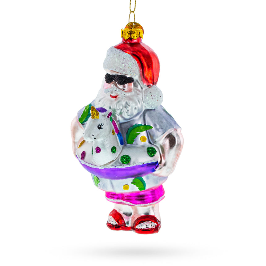 Glass Santa Lounging in a Unicorn Floatie Glass Christmas Ornament in Multi color