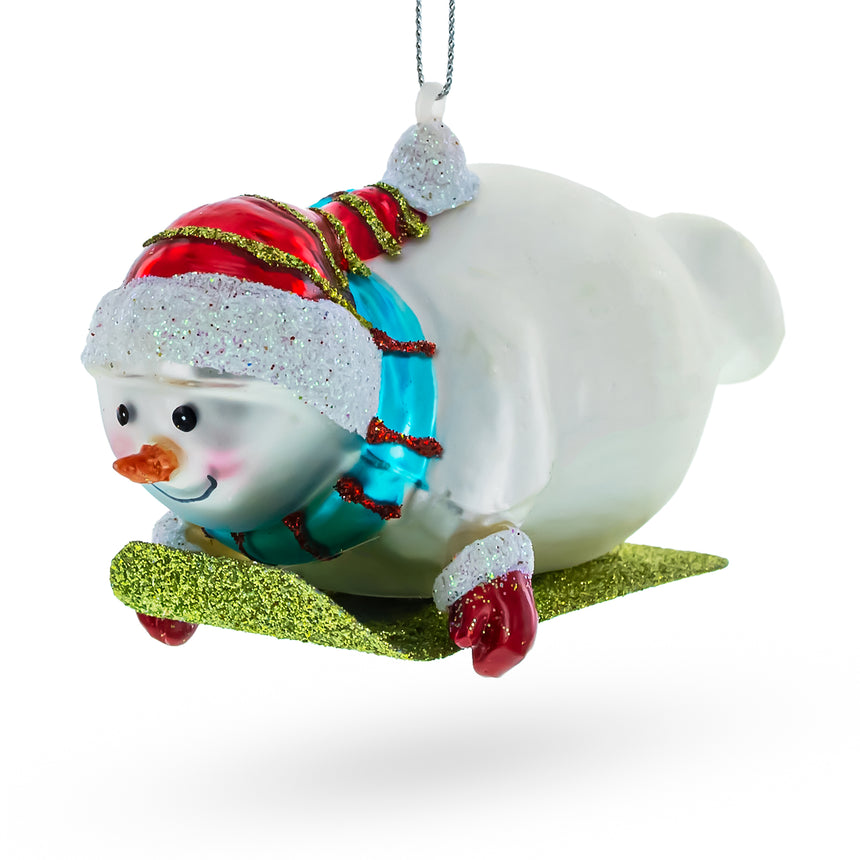 Glass Snowman Gleefully Riding a Sled Glass Christmas Ornament in White color