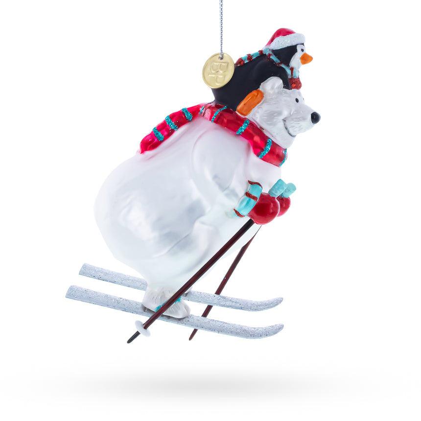 Skiing Polar Bear with Penguin Blown Glass Christmas Ornament ,dimensions in inches: 5.1 x 2.2 x 3.2