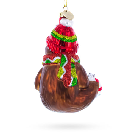 Festive Sloth with Mug Blown Glass Christmas Ornament ,dimensions in inches: 4.7 x 3 x 2.6