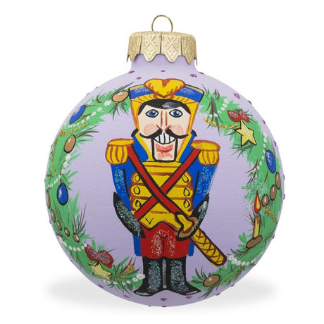 Glass Regal Festivity: Nutcracker Soldier Amidst Wreath Blown Glass Ball Christmas Ornament 3.25 Inches in Purple color Round