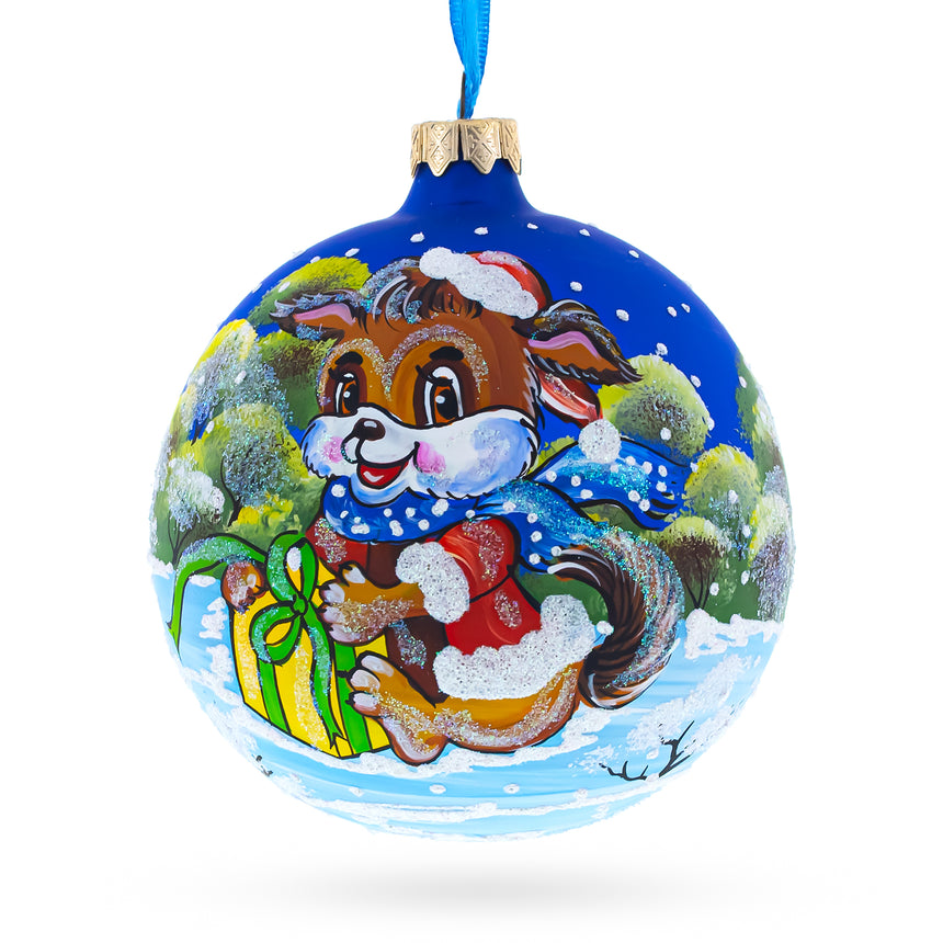 Glass Puppy Unwrapping a Surprise Blown Glass Ball Christmas Ornament 4 Inches in Blue color Round