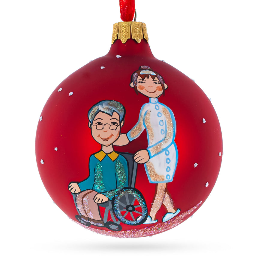 Glass Caregiver with Woman in Wheelchair Blown Glass Ball Christmas Ornament 3.25 Inches in Red color Round