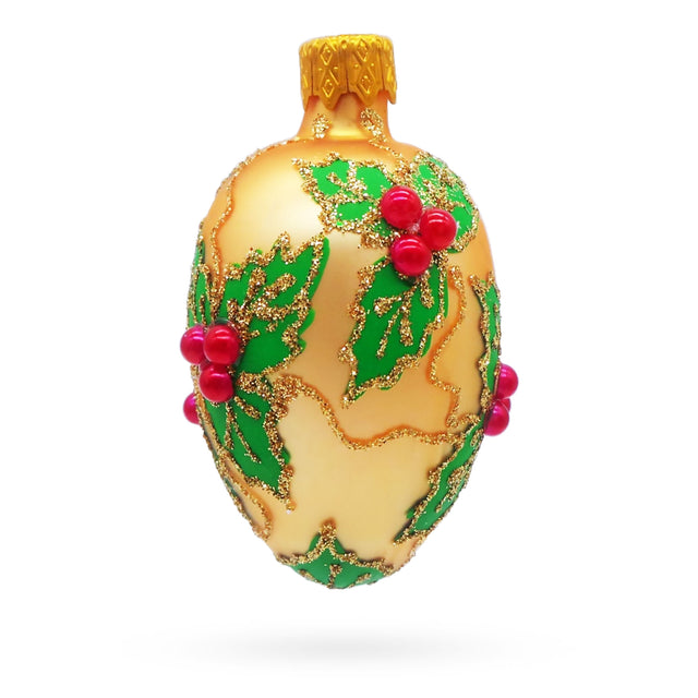 Glass Golden with Holly Leaf and Red Berry Accents Mini Glass Egg Ornament in Gold color Oval