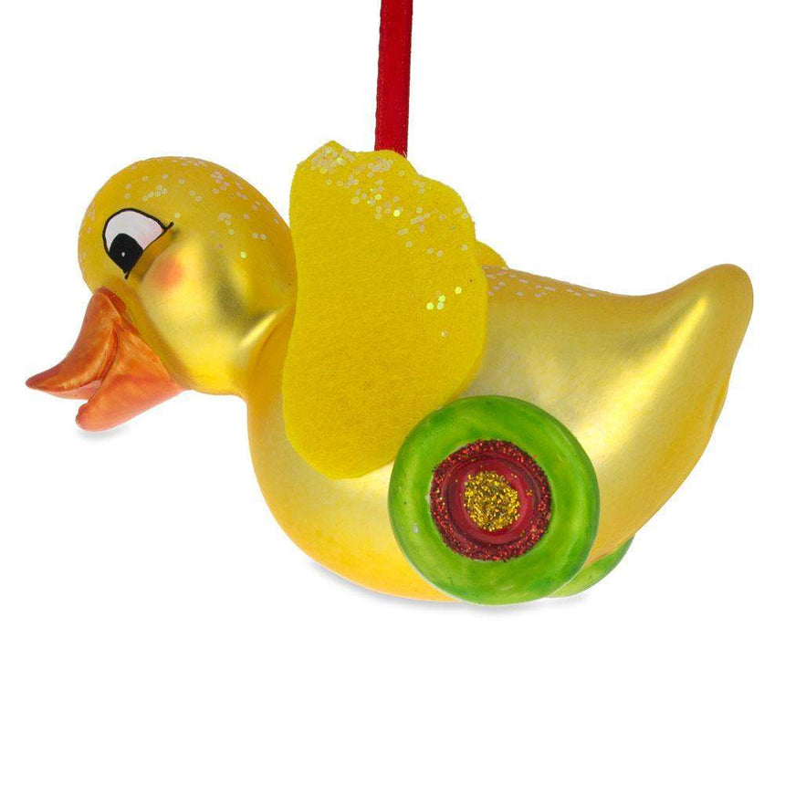 Glass Yellow Duck Rolling on Wheels Blown Glass Christmas Ornament in Yellow color