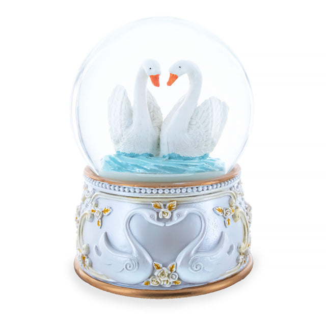 Glass Enchanted Swans Spinning Musical Water Snow Globe in White color Round