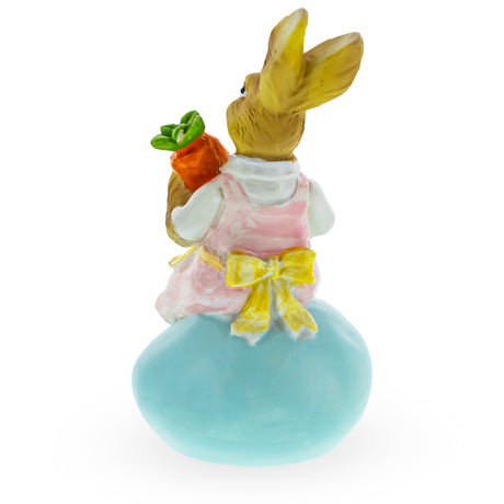 Springtime Serenity: Mother Bunny Cradling Carrot Atop a Decorative Easter Egg Figurine ,dimensions in inches: 5.2 x 2.9 x 2.5